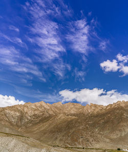Scenic view of desert against blue sky
