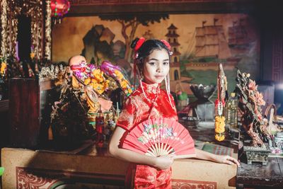 Young woman sitting on display at home