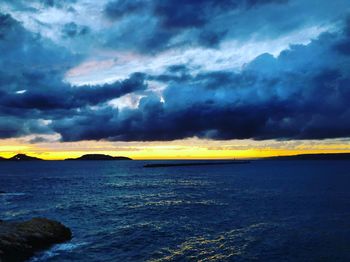 Scenic view of sea against storm clouds