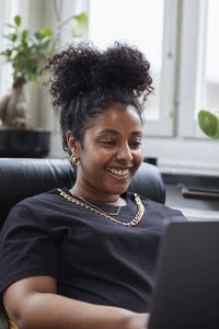 Woman on chair using laptop