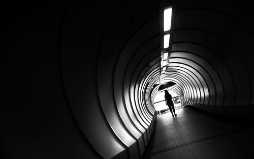 Rear view of woman walking in subway