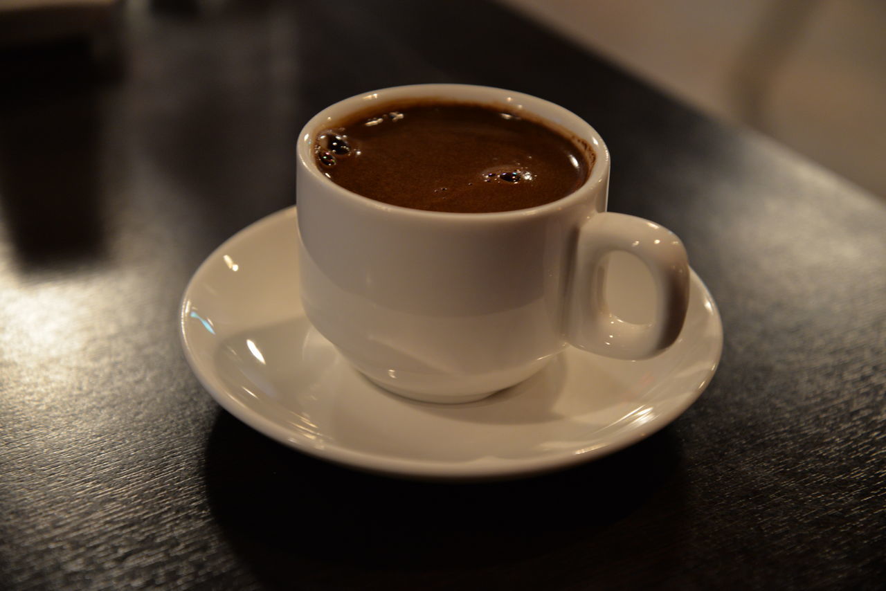 CLOSE-UP OF COFFEE AND CUP ON TABLE