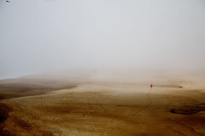 Scenic view of field against sky during winter