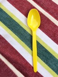 High angle view of plastic spoon on table