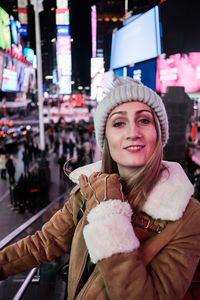 Portrait of a smiling young woman in times square