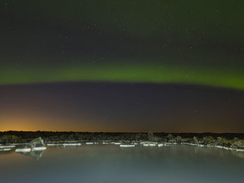 Scenic view of lake against sky at night