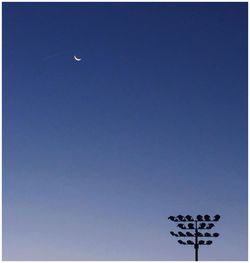 Low angle view of moon against blue sky