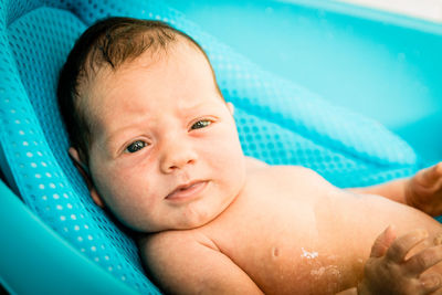 Portrait of shirtless baby boy in swimming pool