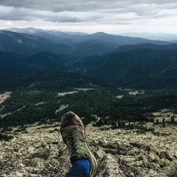 Low section of person against mountains