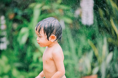 Full length of shirtless boy in water