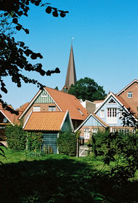 Low angle view of trees and buildings against sky