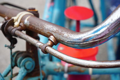 Close-up of rusty chain on railing