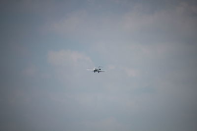 Low angle view of airplane flying in sky