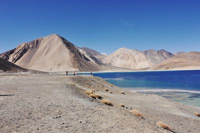 Scenic view of mountains against clear blue sky