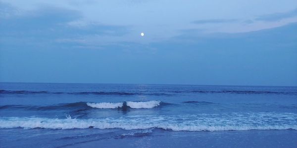 Scenic view of sea against blue sky