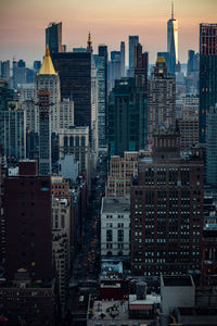 Aerial view of buildings in city against sky