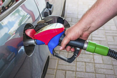 Cropped hand of man washing car