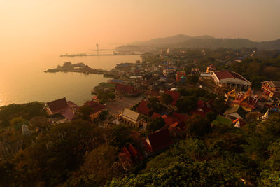 High angle view of town by sea against sky