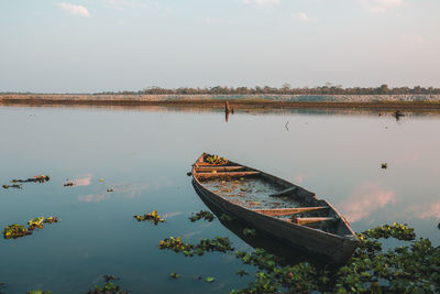 Boats moored in lake against sky