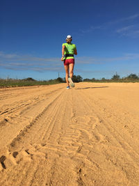 Full length of woman on sand against sky