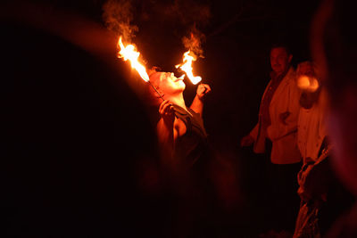 Man performing with fire during event at night