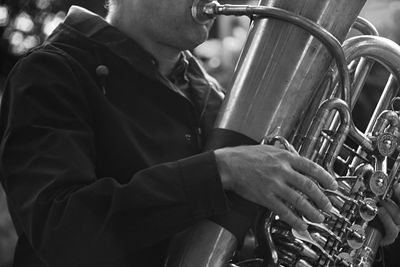 Midsection of man playing tuba