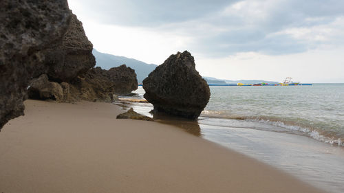 Rocks on beach against sky