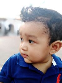 Close-up of cute boy looking away 