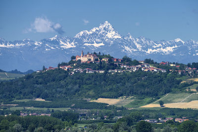 Scenic view of buildings and mountains against sky