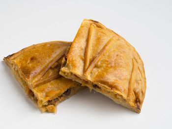 High angle view of bread in plate against white background