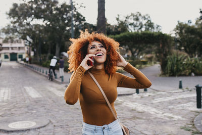Young woman standing on street in city