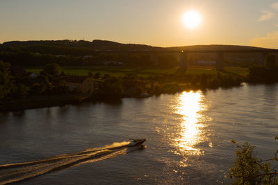 Scenic view of river against sky during sunset