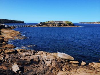 Scenic view of sea against clear blue sky