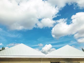 Low angle view of building against cloudy sky