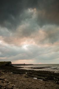 Scenic view of beach against sky during sunset