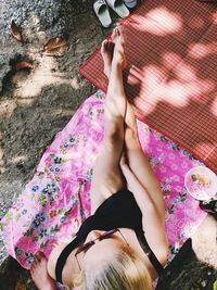 High angle view of woman lying on pink floor