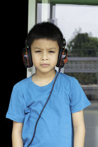 Portrait of boy listening music through headphones