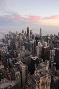 Aerial view of buildings in city against sky