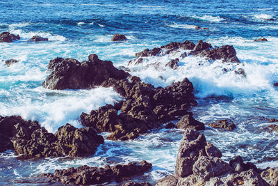 Waves splashing on rocks at shore