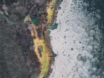 Aerial view of a frozen lake. ice sheet background. frozen grass on the lake. ice background.