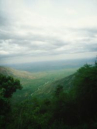 Scenic view of landscape against cloudy sky