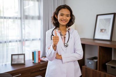 Portrait of female doctor standing in office