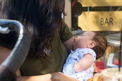 Mom with a newborn baby at an outdoor cafe