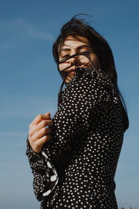 Woman standing against sky