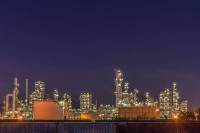 Illuminated buildings against sky at night