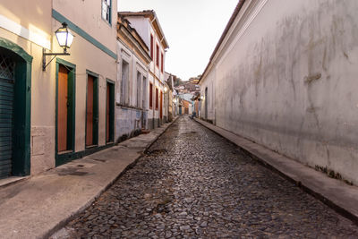 Empty alley amidst buildings in city