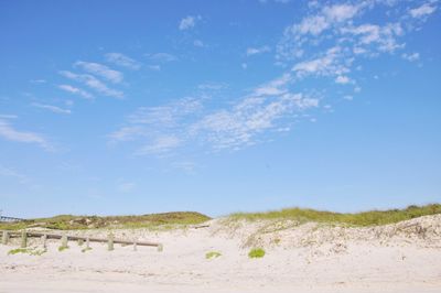 Scenic view of beach against blue sky