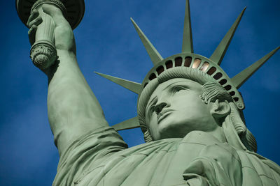 Low angle view of statue against blue sky