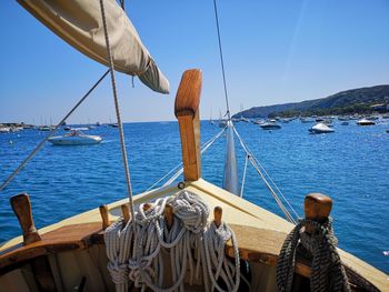 Sailboats sailing in sea against clear blue sky