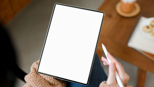 Midsection of woman using digital tablet